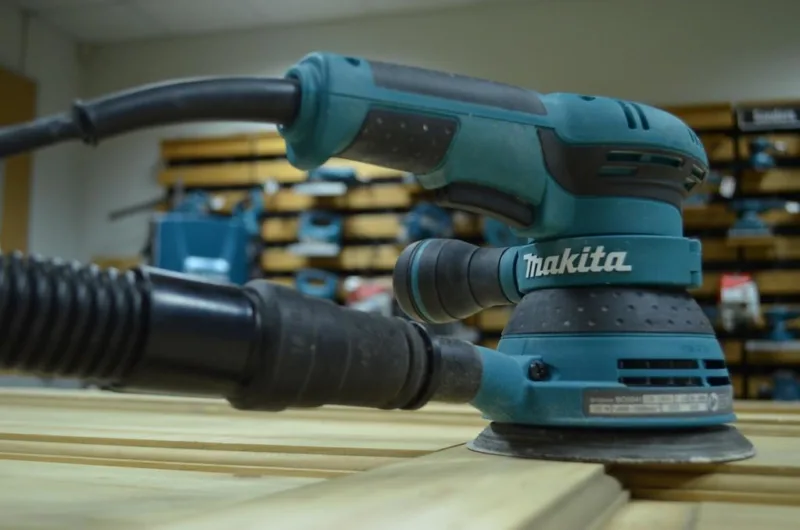 Use an orbital sander like this on edges and corners
